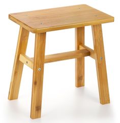 a small wooden stool sitting on top of a white floor