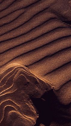 the sand is wavy and brown in color