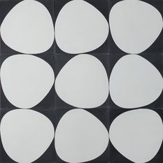 several white circles are arranged on a black and white tile