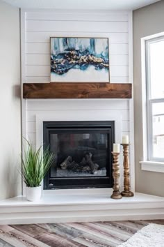 a living room with a fire place and a painting on the fireplace mantels