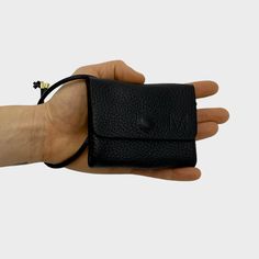 -Folded small leather wallet with nappa leather strap to carry -Measures 9,5 cm X 7,5 cm X 1,5 cm (W X H X D) -Round hemmed nappa leather strap 75 cm long with adjustable knot -Hidden stainless steel push button for secure closing -Made of fine embossed cowhide from Germany, 1,1-1,3 mm thick -Handmade in Portugal The high quality, handmade Mini wallet 1. 3 with round hemmed nappa leather strap not only looks great, it can be worn around the wrist or tied in a large bag so you can find it quickly and no one can steal it from you. The leather wallet is a true packing artist. Up to 10 ec and credit cards + folded bills + coins have space here despite the mini format. For going out, eating ice cream and stealing horses, simply every day a faithful companion. Two compartments store all your cre Compact Leather Coin Purse, Versatile Compact Leather Coin Purse, Leather Card Holder Gift, Minimalist Bifold Coin Purse With Coin Pocket, Minimalist Leather Coin Purse For Gift, Minimalist Leather Coin Purse As Gift, Card Holder With Card Slots For Daily Use, Soft Leather Rectangular Coin Purse As Gift, Minimalist Leather Rectangular Coin Purse