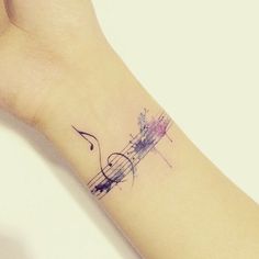 a tattoo with musical notes on the wrist