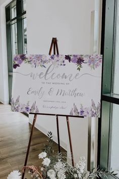 a welcome sign sitting on top of a wooden easel