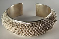 "Dok Phikoun Fine Silver Adjustable Back Open End Bangle Bracelet is an intricately handcrafted Dok Phikoun jewelry from highly skilled artisans based in Laos, a country located in Southeast Asia. \"Dok Phikoun\" translates to \"dok\" meaning flower and \"phikoun\" meaning silver, thus referring to silver flower jewelry.  This unique piece of jewelry is made from high-quality silver and crafted by skilled artisans. The jewelry features intricate and delicate floral designs such as frangipani, lo Luxury Handmade Cuff Bangle, Luxury Adjustable Cuff Bracelet With Intricate Design, Luxury Handmade Adjustable Bangle, Traditional Cuff Jewelry As Gift, Traditional Cuff Jewelry For Gifts, Adjustable Sterling Silver Bracelet For Festivals, Elegant Sterling Silver Bracelet For Festivals, Elegant Adjustable Sterling Silver Festival Bracelet, Elegant Engraved Cuff Bracelet For Festivals