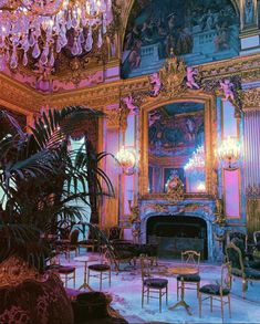 an ornately decorated room with chandeliers and chairs