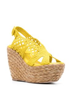 120mm leather platform sandals from PALOMA BARCELÓ featuring sunset yellow, interwoven design, buckle-fastening ankle strap, branded leather insole, open toe, braided raffia platform, braided raffia wedge heel and calf leather trim. Size Info IT Color Detail Yellow Made In Spagna Material Outer: Calf Leather 100%, Raffia 100% Lining: Calf Leather 100% Sole: Rubber 100%, Calf Leather 100% Season One Spring-Summer Season Two Spring-Summer Product sandals Brand Paloma Barcelò Size And Fit Heel 4,7 Spring Closed Toe Sandals With Intrecciato Weave, High Heel Sandals With Woven Straw Sole, Straw Sandals With Braided Ankle Straps, Luxury Straw Sandals For Summer, Luxury Summer Straw Sandals, Luxury Summer Heels With Woven Sole, Luxury Open Toe Straw Sandals, Spring Open Toe Heels With Intrecciato Weave, Intrecciato Weave Open Toe Summer Heels