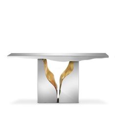 a white table with two gold leaves on the top and one silver plate in the middle