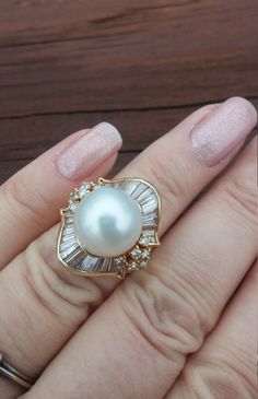 "ATTENTION BUYERS.. PLEASE READ ANNOUNCEMENT IN MY SHOP. it's very important information there about purchasing items. Must purchase thru Etsy only, NOT from \" Offsite ads\"Stunning Vintage 14k Yellow Gold, South Sea, Salt Water 12.34mm White Pearl, approximately 2ct  Baguette And Round Diamonds Wedding Engagement Cocktail Ballerina Ring.. Ring Measurements is approximately 22.58mm x 20mm Diamonds is SII, GH. Weight is 9.3 Grams Size 5 1/4, sizable. Some pics enlarged to see details All sales are final, no return. Ring look Spectacular, Rich and Classy on your finger. US shipping overnight with insurance only $59 International shipping with USPS Express $89 All Dimensions, Measurements and description is approximately Layaway plan is available Ring will come in nice gift box..ATTENTION BU High Luster Diamond Wedding Rings, Aaa Quality Baguette Cut Wedding Jewelry, Navette Ring, Ballerina Ring, Gold Pearl Ring, Gold Ring Designs, Diamond Jewelry Designs, Sea Pearl, Gold Work