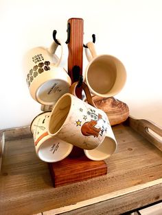 several coffee cups are sitting on a wooden stand