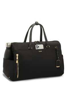 Leather trim subtly elevates this modern duffle bag with plenty of space to keep you organized no matter where you're going. A removable, adjustable crossbody strap means convertible convenience each time you choose this bag with quick-access pockets on the outside and a water-resistant water-bottle pocket. This bag includes Tumi Tracer®, an exclusive, complimentary program that helps reunite lost or stolen bags with their rightful owners using a one-of-a-kind 20-digit number affixed to the bag Elegant Weekender Bag With Adjustable Strap For On-the-go, Elegant Duffle Bag With Adjustable Strap, Elegant Duffle Bag With Adjustable Strap For On-the-go, Elegant Crossbody Travel Bag With Adjustable Strap, Elegant Weekender Shoulder Bag With Adjustable Strap, Elegant Weekender Bag With Adjustable Strap, Chic Duffle Bag With Adjustable Strap For On-the-go, Chic Top Handle Duffle Bag For Travel, Elegant Duffle Bag With Zipper Closure For Travel