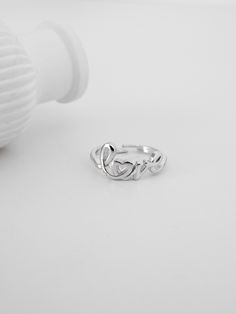 Introducing our enchanting Silver "Love" Ring, a timeless piece that beautifully intertwines sentiment and elegance. This exquisite ring is crafted from the finest S925 sterling silver, ensuring longevity and a radiant shine that transcends time. The word "love" is artistically written in a delicate cursive script, with the cleverly designed as a heart, symbolizing the endless nature of love. This unique design makes it more than just a piece of jewelry; it becomes a cherished keepsake. Elegant Love In Cursive, Love Script, Cursive Script, Ring Elegant, Timeless Gifts, Romantic Gift, Love Ring, Adjustable Ring, Adjustable Rings