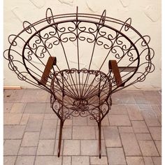 a metal chair sitting on top of a brick floor