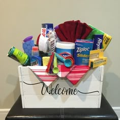 a welcome sign with various items in the shape of a boat on top of a stool