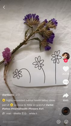 a flower is on the side of a white plate with stickers attached to it