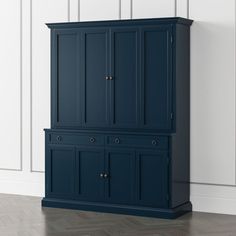 a blue armoire with two doors and drawers on the bottom shelf, against a white wall