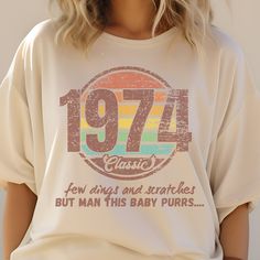 a woman wearing a white t - shirt with the number seventy years printed on it