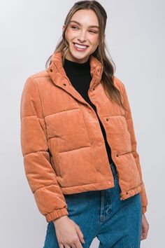 Get cozy in this high neck corduroy puffer jacket with zip and snap front and side hand-warmer pockets. A packable pick, this coat has a toggle bottom for extra warmth.  Zippered and snap front Side pockets  Toggle bottom Fabric Contents: Self: 90% Polyester 10% Nylon; Lining: 100% Polyester: Filling: 100% Polyester Color: Spice Dimensions: Small:  Bust: 42" Length: 22" Medium:  Bust: 44" Length: 22.5" Large: Bust: 46" Length: 23" Machine Wash Cold Gentle Do Not Bleach Do Not Tumble Dry Do Not D Cotton Puffer Jacket For Fall, Orange Cotton Winter Outerwear, Winter Orange Cotton Outerwear, Casual Puffer Jacket With Button Closure For Cold Weather, Winter Corduroy Outerwear With Button Closure, Corduroy Outerwear With Snap Buttons For Winter, Casual Orange Outerwear With Buttons, Trendy Orange Outerwear With Button Closure, Corduroy Puffer Jacket