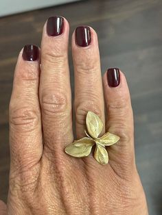 This exquisite 18K solid yellow gold ring features a unique butterfly design, with matte-finished wings carved in the shape of leaves for a stunning and intricate detail. Measuring 1" in length, this beautiful lady's ring is truly a work of art and a conversation piece. Its exceptional craftsmanship and distinctiveness make it an excellent choice for anyone seeking a striking and unique piece of jewelry. Ring size 7 Gold Luxury Butterfly Ring For Formal Occasions, Luxury Gold Butterfly Ring For Formal Occasions, Gold Formal Rings With Nature-inspired Style, Gold Butterfly Ring For Wedding, Gold Formal Butterfly Ring, Gold Nature-inspired Rings For Formal Occasions, Formal Yellow Gold Butterfly Ring, Formal Yellow Gold Butterfly-shaped Ring, Yellow Gold Butterfly Ring For Formal Occasions