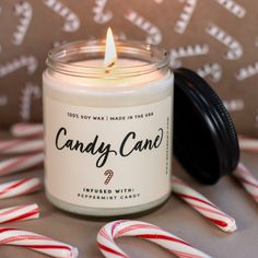 a candle with candy canes around it