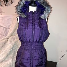 Deep Purple Puffer Vest With Detachable Fur Lined Hood. Zippered Front, Lightweight Yet Warm. Pockets On Sides And Slight Ruching For Flattering And Stylish Fit. Nwot Size L Purple Stretch Outerwear For Fall, Purple Outerwear For Cold Weather In Spring, Casual Purple Outerwear For Cold Weather, Fitted Purple Winter Outerwear, Trendy Purple Outerwear, Purple Gray, Puffer Vest, Purple Grey, Deep Purple