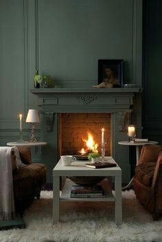 a living room filled with furniture and a fire place in the middle of the room