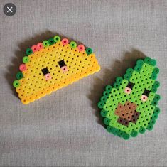 two pieces of perler bead are sitting on a table together, one is yellow and the other is green