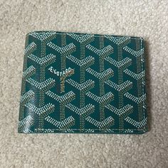 Brand New W/Tags - Bfold Men's/Unisex Wallet - In Beautiful And Most Coveted Green. Harder And Harder To Get These Days. Goyard Is Limiting Their Colors And Sales Of Items. Goyard Just Did Their Price Increase For 2024 So Prices Have Gone Up Again! Beautiful Goyard Card Holder In Brilliant House Color Green. A Traditional Color And A Timeless Classic Piece. Goyardine Canvas And Calfskin Leather. This Is A Rare Beautiful Color! In Perfect/Mint Condition. Unworn, Unused. Negotiable. Offers Accepte Designer Gold Bifold Wallet, Designer Green Wallet With Interior Card Slots, Designer Green Wallets With Interior Card Slots, Green Designer Wallets With Interior Card Slots, Luxury Green Wallets With Interior Card Slots, Green Luxury Wallets With Interior Card Slots, Luxury Green Wallet With Interior Card Slots, Green Luxury Wallet With Interior Card Slots, Designer Green Wallet For Daily Use