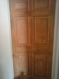 an open wooden door in a white room