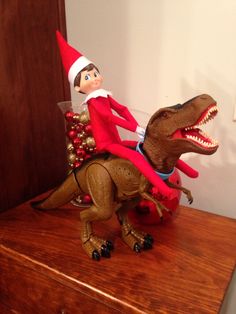 an elf riding on the back of a dinosaur toy