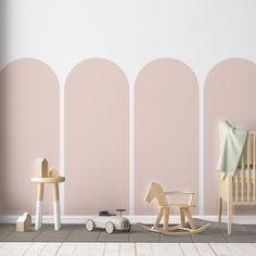 a baby's room with pink and white walls