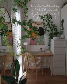 a living room filled with furniture and lots of green plants