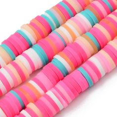 three rows of multicolored plastic beads on a white background