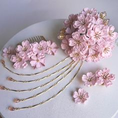 pink flowers and hair pins on a white plate