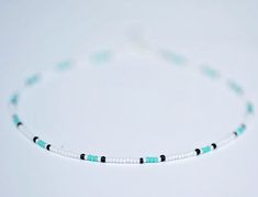 The Classic surfer necklace  has select sizes available with an adjustable 2-inch extender chain to comfortably fit any size neck. made of czech sea blue seed beads with white and black glass seed beads.  Perfect for layering with other necklaces or chokers and great to wear with any outfit. It is made for any look you want; a cute choker or a collarbone necklace.  It is carefully crafted to ensure durability so you can wear it everyday! Each beautifully beaded necklace is handmade uniquely made for you. Visit my shop to check out more beautiful necklaces, anklets, and rings! I hope to provide a positive purchase experience for my customers. Please feel free to message me with any questions and/or concerns and I will be happy to answer them :) If you are unhappy with your item in any way, Adjustable White Necklace For Friendship, Collarbone Necklace, Seed Bead Necklaces, Teal Necklace, Cowgirl Necklaces, Diy Friendship Bracelets Tutorial, Autumn Necklace, Bracelets Tutorial, Diy Friendship Bracelets