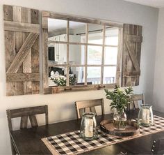 a dining room table with a checkered placemat and vases on top of it