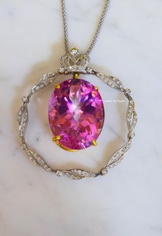 Metal: 14kt White And Yellow Gold Stone: Diamond And Pink Topaz Shape: Oval Pink Topaz And Round Diamonds Pink Topaz Weight: 63.90 ctw Diamond Weight: .87 ctw Weight of entire piece with chain: 28.80 grams Length Of Pendant From Top To Bottom: 54.03mm Width Of Pendant: 49.43mm Type of chain: 14kt White Gold Popcorn Chain. 1.70mm wide. Type of Lock: Lobster Clasp Type of Bail: Slide Through Length of chain: 16 Inch Note: Other chain styles and lengths available upon your request. Pendant can also Elegant Round Pink Sapphire Gemstones, Gold Formal Necklace With Center Stone, Formal Gold Necklace With Center Stone, Luxury Pink Jewelry Collectible, Luxury Pink Collectible Jewelry, Luxury Necklace With Center Stone As Gift, Gold Popcorn, Family Necklace, Pink Topaz