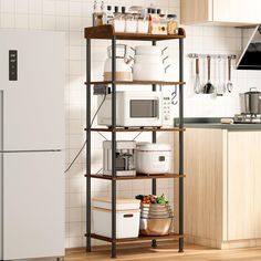 a white refrigerator freezer sitting inside of a kitchen next to a wooden shelf filled with pots and pans