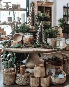 a table topped with lots of baskets and christmas tree decorations on top of each other