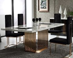 a modern dining table with black chairs and white marble top