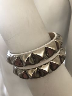 "Classic punk bracelet with two rows of pyramid studs. Studs are 1/2\" across. Studs are steel with nickel plating, hardware is brass with nickel plating. Made with hand dyed vegetable tan leather. Pink sparkle leather is an additional coating applied over dyed leather and may flake off a little around where the buckle fastens. Note: 5.5\"-6.25\" and 6.5-7.25\" bracelets have snaps instead of buckles. The studs are closer together on these than the other bracelet, see pix for details. For best r Silver Punk Bracelets With Studs, Punk Style Silver Bracelet With Studs, Metal Studs Bracelets For Party, Metal Bracelets With Studs For Party, Metal Spiked Leather Bracelet For Parties, Edgy Silver Leather Bracelet With Studs, Metal Party Bracelets With Studs, Silver Spiked Bracelets For Parties, Party Bracelets With Metal Studs