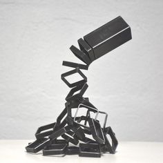 a pile of black objects sitting on top of a white table