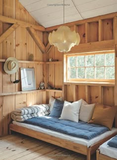 a bed in a room with wooden paneling and walls that are made out of boards