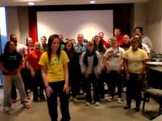 a group of people standing in front of a projector screen