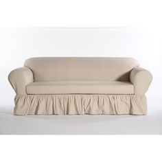 a couch with a ruffled cover on it's back and the seat upholstered