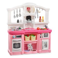 a toy kitchen with pink counter tops and white appliances