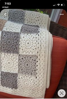 a crocheted blanket sitting on top of a couch