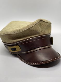 Handmade and hand-stiched leather and suede army cap. Please indicate your size as the badge is limited. Military Style Brown Hat With Curved Brim, Brown Military Hat With Curved Brim, Military Style Brown Cap, Brown Military Style Cap, Vintage Leather Hats For Outdoors, Brown Military Brimmed Hat, Brown Military Visor Hat, Brown Military Flat Cap, Military Style Brown Flat Cap