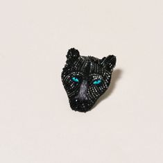 Explore the intricately beaded and embroidered black Panther brooch. This handmade panther brooch is made with imitation rhodium plated brass, embroidery thread, seed beads, cut bugle beads and genuine leather backing. Black Panther Embroidery, Sports Earrings, Panther Jewelry, Baseball Earrings, Embroidered Earrings, Football Earrings, Embroidered Brooch, Mignonne Gavigan, Beadwork Designs