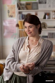 a woman sitting in front of a computer desk