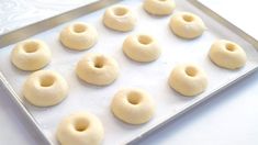 small doughnuts on a baking sheet ready to go into the oven or bake